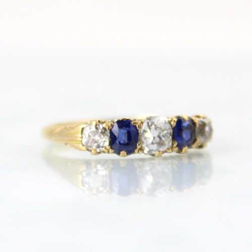 145 - A Victorian diamond and untested sapphire ring, the central old cut diamond with cushion cut unteste... 