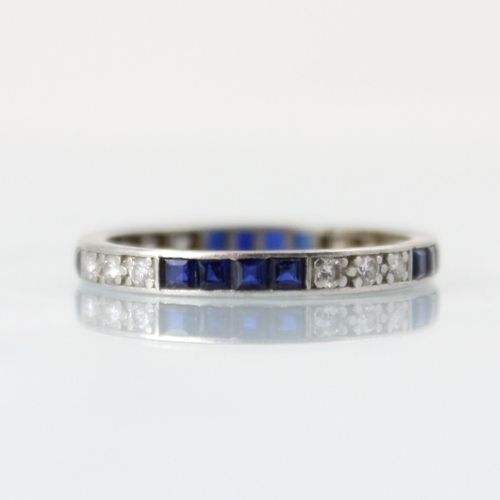 150 - An Art Deco diamond and untested sapphire full eternity ring, the three round cut diamonds with four... 