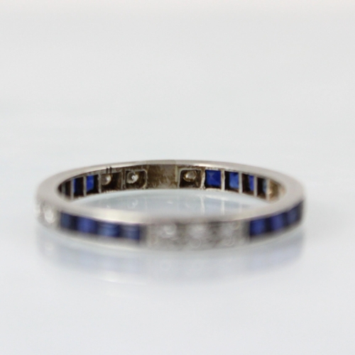 150 - An Art Deco diamond and untested sapphire full eternity ring, the three round cut diamonds with four... 