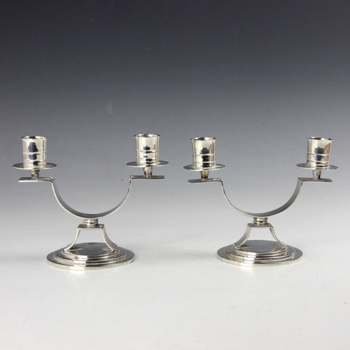 32 - A pair of George V silver candlesticks, Adie Brothers Ltd, Chester 1935, the twin sconces above loop... 