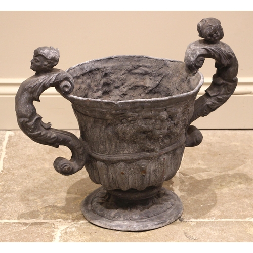 532 - A 19th century lead planter, of lobed campana form, cast in relief with foliate detail and cherub ma... 