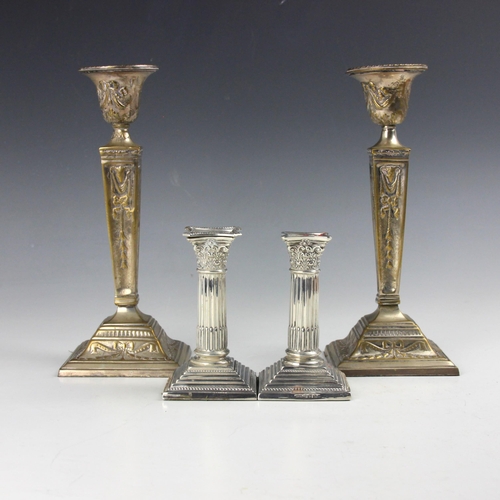 56 - A pair of Edwardian silver dwarf candlesticks, W G Keight, Birmingham 1901, the Corinthian columns a... 