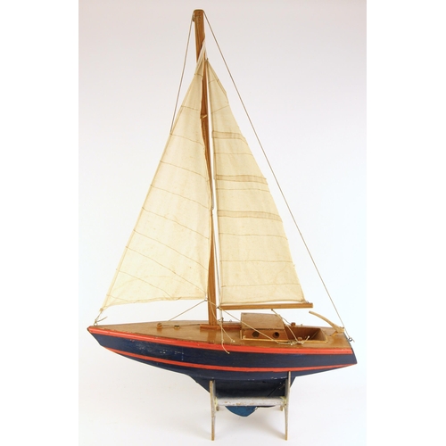 563 - A scratch built pond yacht, probably mid 20th century, the wood and plywood hull with metal keel, th... 