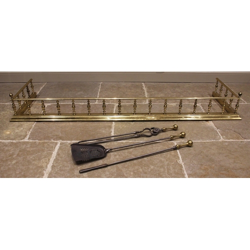 595 - A Victorian brass fire fender, of country house proportions, formed with a spindle gallery to a kerb... 