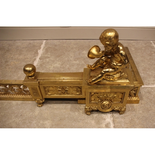 596 - A late 19th century French lacquered brass chenet fender, each of the end sections cast as a plinth ... 