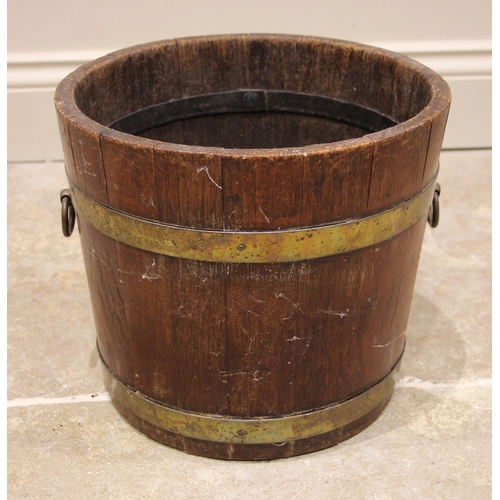 598 - A George III oak and brass bound coopered peat bucket, applied with side ring handles, lacking liner... 