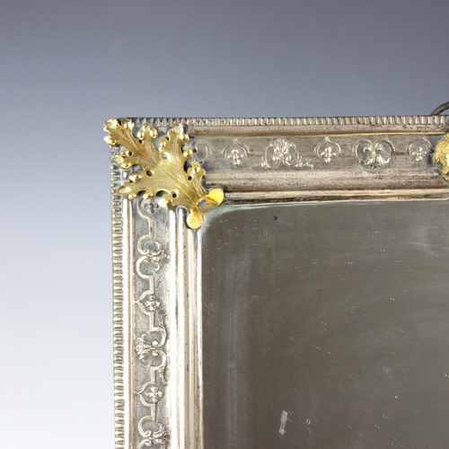 62 - A 19th century silver coloured and gilt metal dressing table mirror, of rectangular form with stylis... 