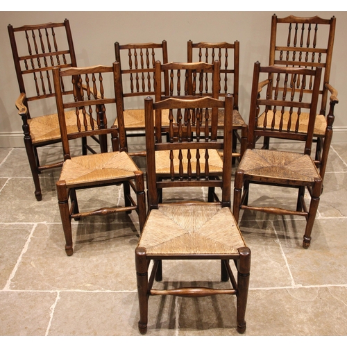 676 - A matched set of eight ash Lancashire spindle back, rush seated kitchen chairs, 19th century, to inc... 