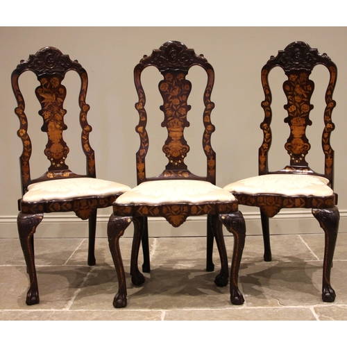 677 - A set of three Dutch marquetry walnut dining chairs, 18th century and later, each with a shell carve... 