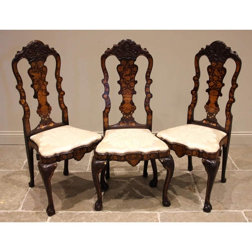 677 - A set of three Dutch marquetry walnut dining chairs, 18th century and later, each with a shell carve... 