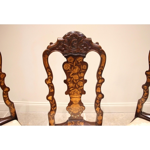 677 - A set of three Dutch marquetry walnut dining chairs, 18th century and later, each with a shell carve... 