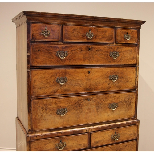 678 - A George I walnut chest on chest, the moulded pediment over an arrangement of three short and three ... 