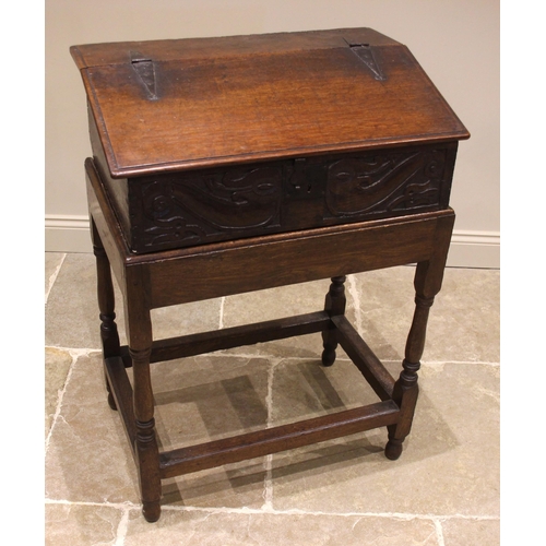 680 - A 17th century and later sloping oak bible box on stand, the hinged cover opening to three pigeon ho... 