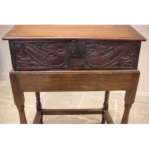 680 - A 17th century and later sloping oak bible box on stand, the hinged cover opening to three pigeon ho... 