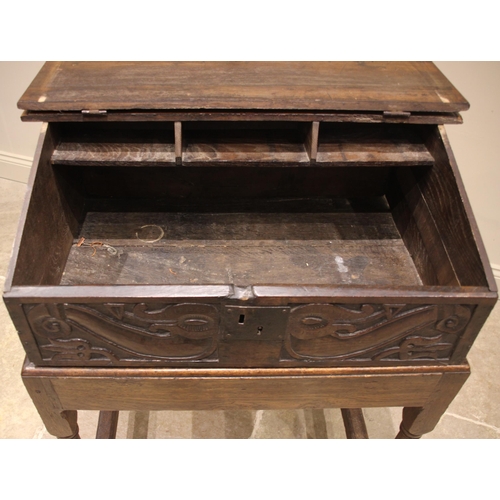 680 - A 17th century and later sloping oak bible box on stand, the hinged cover opening to three pigeon ho... 