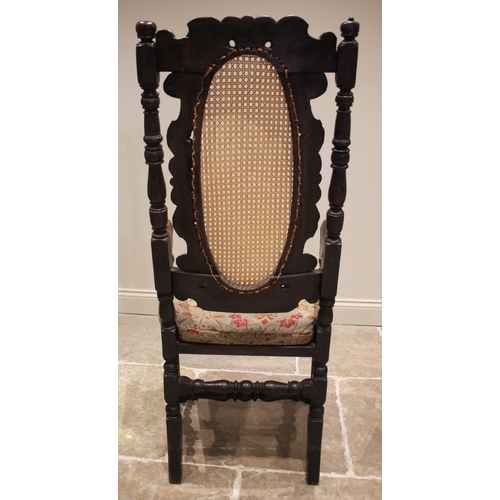 683 - A walnut Carolean open armchair, late 17th century, the high back with a carved coronet crest over t... 