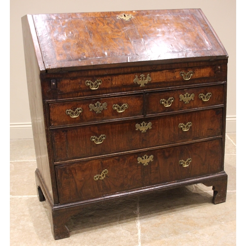 684 - A George II burr elm and oak bureau, the crossbanded and feather banded fall front opening to a cent... 