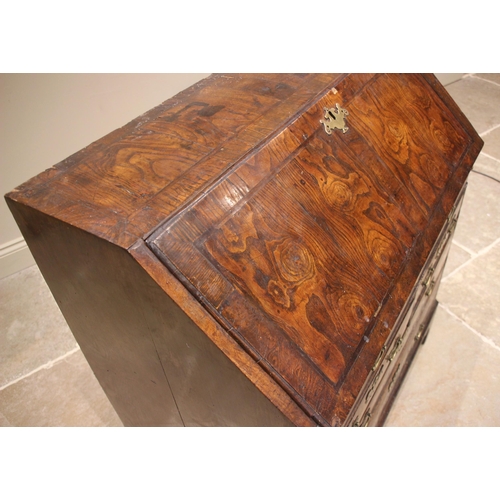 684 - A George II burr elm and oak bureau, the crossbanded and feather banded fall front opening to a cent... 