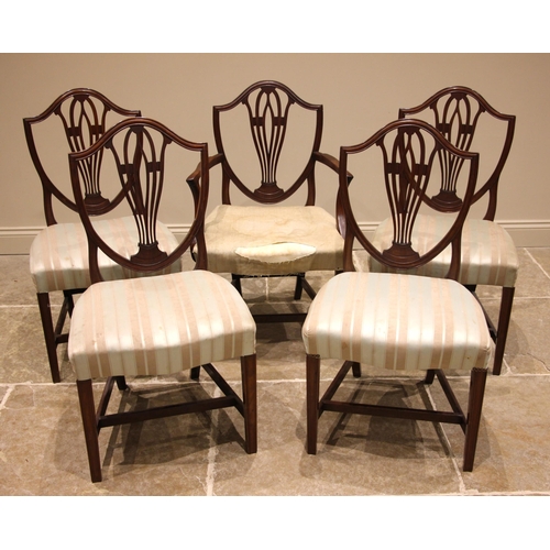 696 - A set of five Hepplewhite style mahogany dining chairs, 19th century, each with a shield shaped back... 