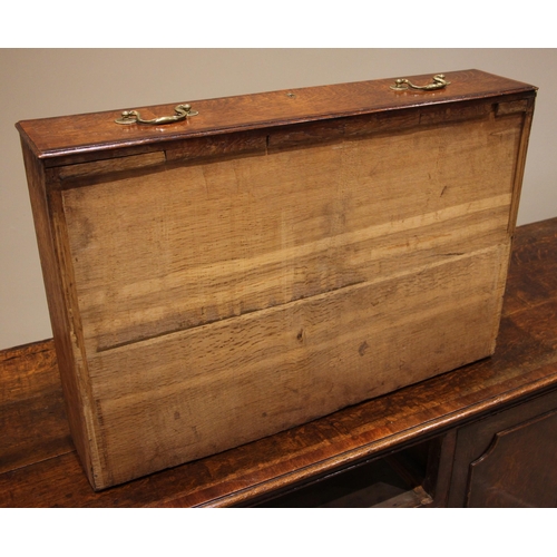 698 - A George III oak and mahogany cross banded Lancashire dresser base, the plank top with rounded front... 