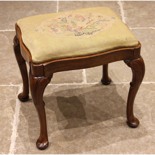 705 - A George II style mahogany stool, late 19th century, the serpentine shaped needlepoint drop-in seat,... 