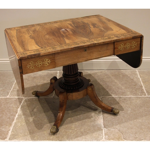 710 - A Regency rosewood and brass inlaid sofa table, in the manner of George Bullock, the drop leaf top w... 