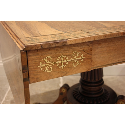 710 - A Regency rosewood and brass inlaid sofa table, in the manner of George Bullock, the drop leaf top w... 