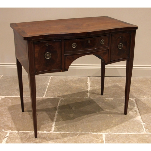 712 - A George III mahogany serpentine side table, the cross banded top over a central oak lined frieze dr... 