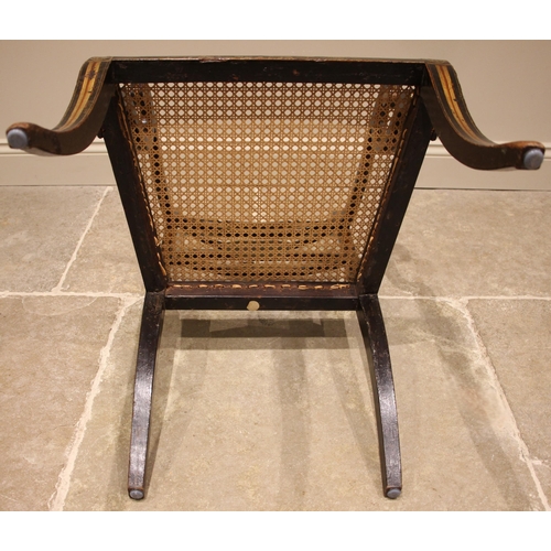 713 - A Regency gilded and ebonised elbow chair, in the manner of Thomas Hope, the turned top rail applied... 