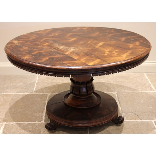 727 - A William IV rosewood breakfast/centre table, the circular top with an open petal frieze, upon a tap... 