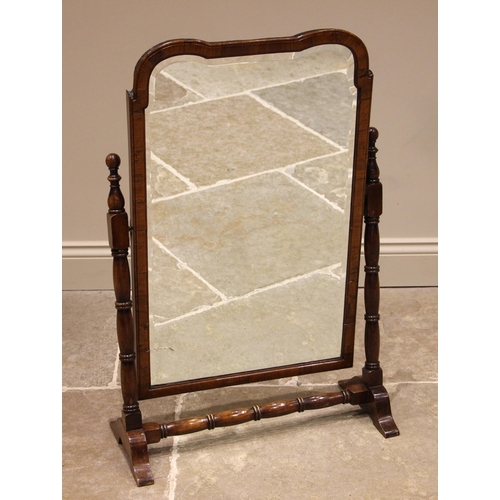 733 - A 19th century walnut cheval mirror, the shaped and rounded frame enclosing a bevelled mirrored plat... 