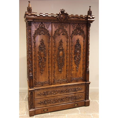 735 - A Scottish baronial oak hall cupboard, late 19th century, the castellated cornice and Gothic spire f... 