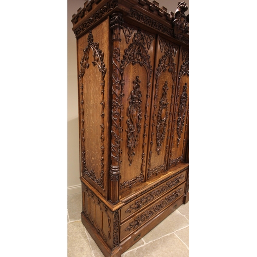 735 - A Scottish baronial oak hall cupboard, late 19th century, the castellated cornice and Gothic spire f... 