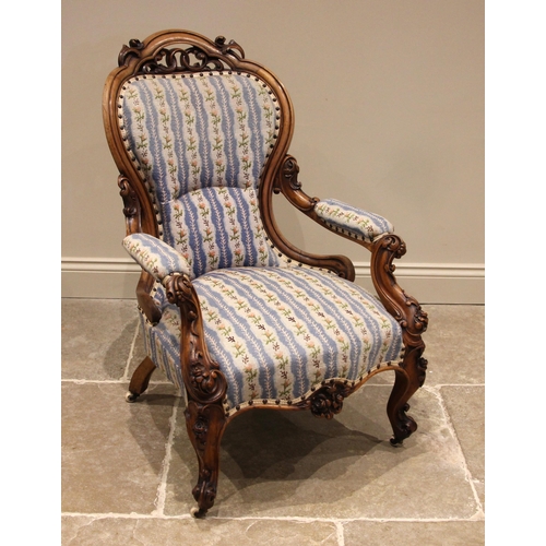 739 - A Victorian walnut framed open armchair, upholstered in rose pattern striped needlepoint fabric, the... 