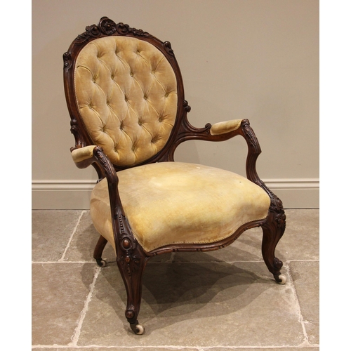 744 - A Victorian carved walnut open armchair, upholstered in gold velour, carved with a foliate crest ext... 