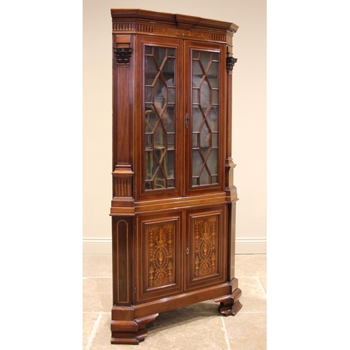 750 - A Sheraton revival inlaid mahogany freestanding corner display cabinet, 19th century, the moulded de... 