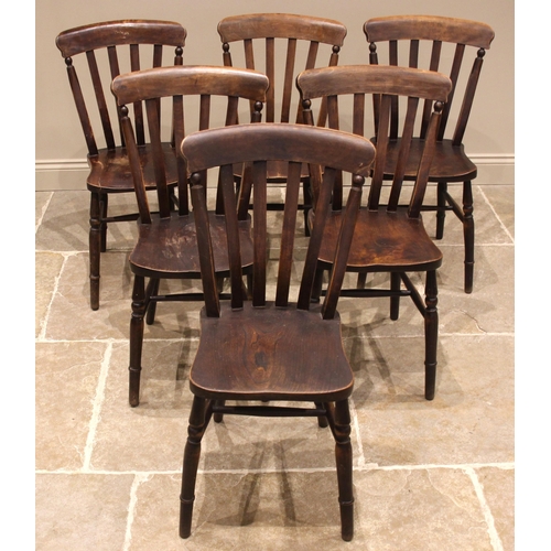 754 - A set of six Victorian elm and beech kitchen chairs, each with a lath back over a shaped and figured... 