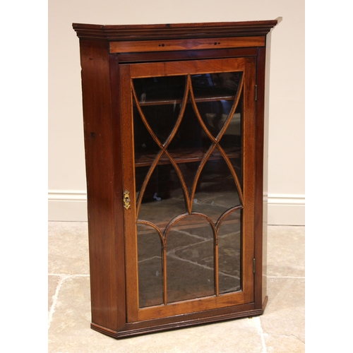 767 - An Edwardian mahogany glazed hanging corner cabinet, the moulded cornice over a satinwood band inlai... 