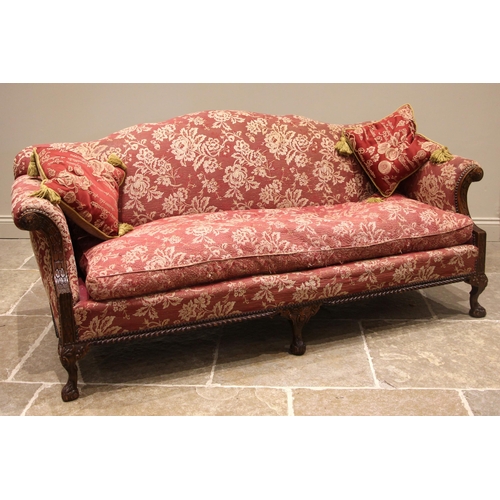 773 - A Chippendale revival sofa, early 20th century, in foliate burgundy fabric, the undulating back rest... 