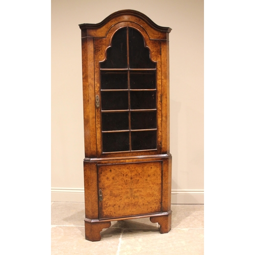 780 - A Queen Anne style burr walnut freestanding corner cabinet, late 20th century, of arched form, the s... 