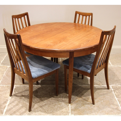 787 - A mid 20th century G Plan teak dining table with six chairs, the circular table with fold out leaf a... 