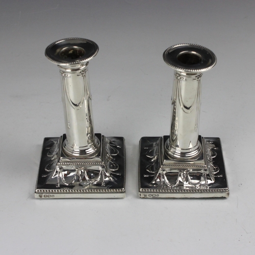 8 - A pair of Victorian silver dwarf candlesticks, Hawksworth, Eyre & Co Ltd, Sheffield 1900, the beaded... 