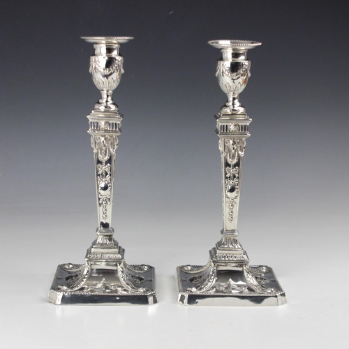 9 - A pair of Victorian silver candlesticks, William Hutton & Sons, London 1892, the urn shaped sconce a... 