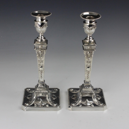 9 - A pair of Victorian silver candlesticks, William Hutton & Sons, London 1892, the urn shaped sconce a... 