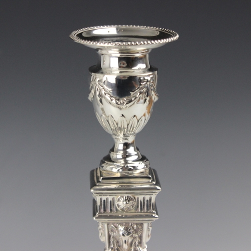 9 - A pair of Victorian silver candlesticks, William Hutton & Sons, London 1892, the urn shaped sconce a... 