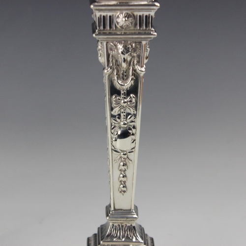 9 - A pair of Victorian silver candlesticks, William Hutton & Sons, London 1892, the urn shaped sconce a... 