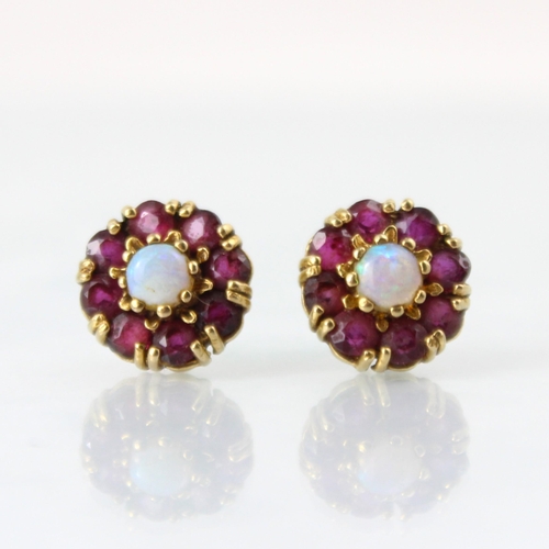 140 - A pair of 9ct yellow gold opal cluster earrings, the central round cabochon opals within surround of... 