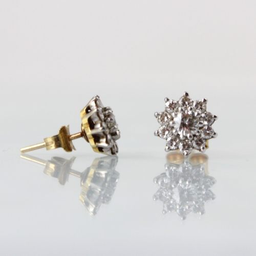 143 - A pair of diamond cluster earrings, the central round cut diamond within a surround of ten smaller r... 