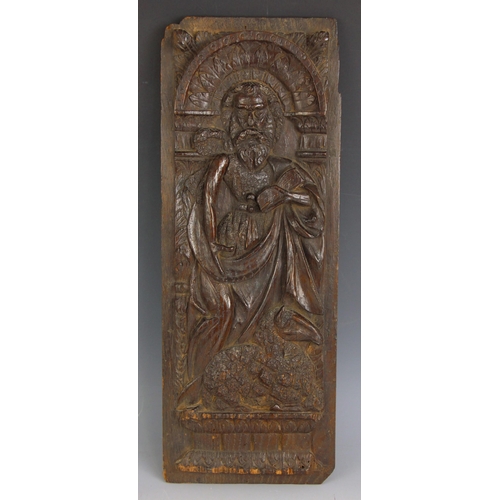 539 - A carved oak panel, possibly 15th century, carved in relief with a figure of St. Francis, sheep at f... 