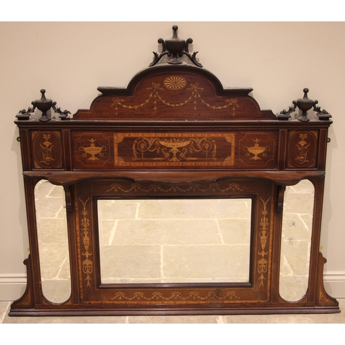 622 - An Edwardian mahogany and marquetry inlaid triptych overmantel mirror, the arched pediment with urn ... 